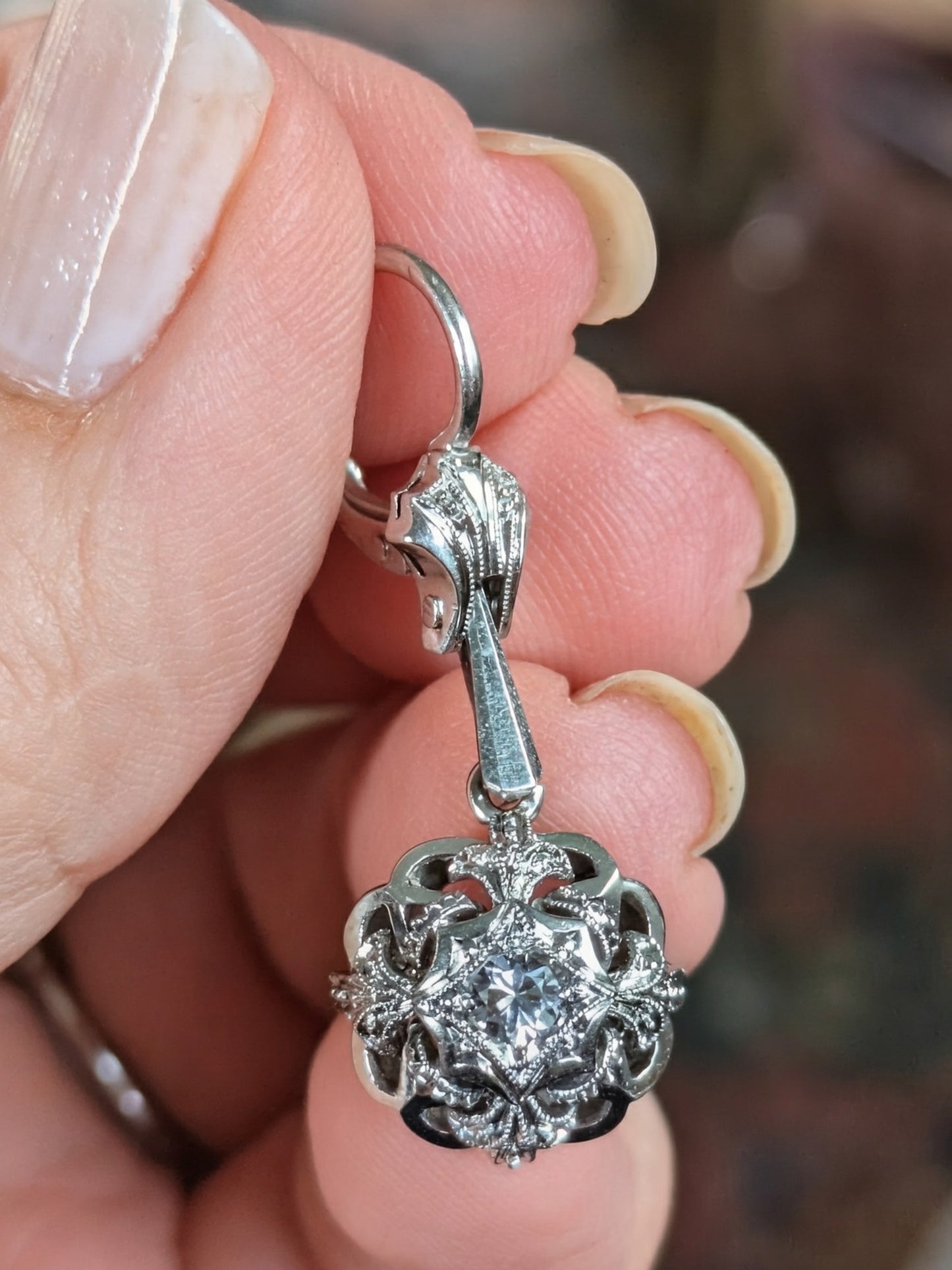 Circa 1950 18k white gold drop dangling earrings with white stones and milgrain detail