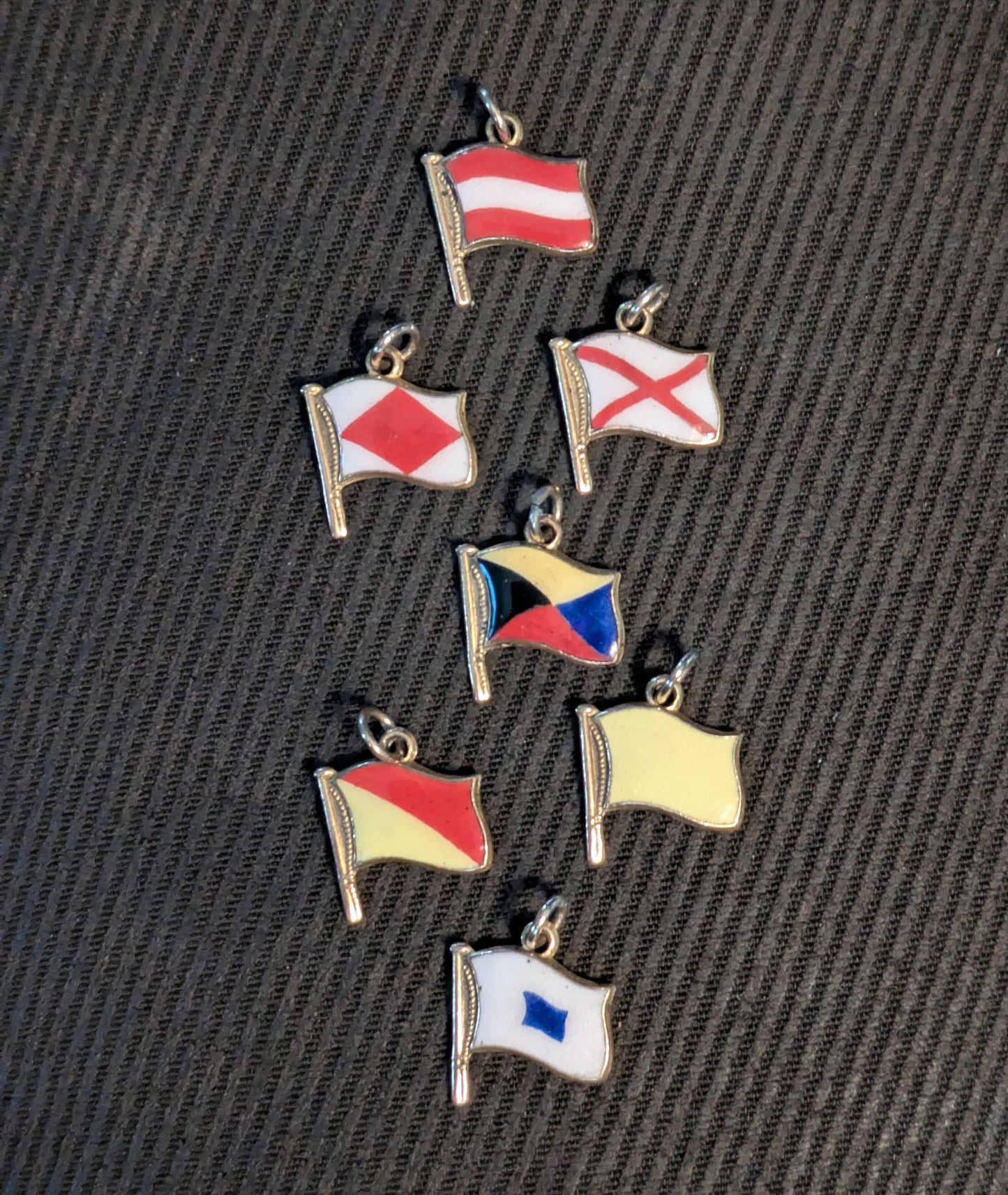Turner & Simson 9k 9c British Nautical Signal Flag charms 1956 date letter and one Austria flag charm.